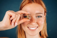 Image woman holding omega-3 capsule supplement