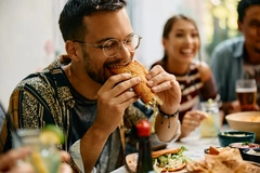 Man biting into burger.