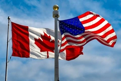 Image The Canada and US flag next to each other.