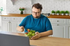 Image Overweight man eating a salad