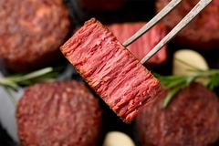 Image Slices of plant based vegan meat steak on meat fork.