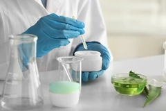 Image A scientist checking skin cream ingredients.