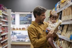 Image Man and child buying pasta in supermarket.