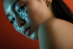 Image woman with rhinestones on face looking at camera