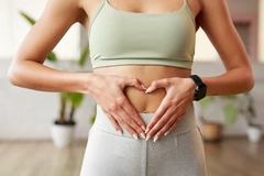 woman holding hands on stomach