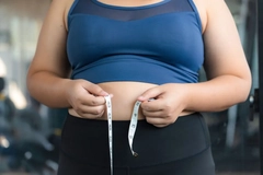 Image obese woman measuring waist