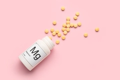Image Bottle of magnesium pills on pink background