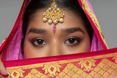 Image A woman wearing traditional clothing, only showing her eyes.
