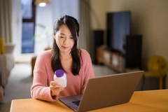 Image Woman checking supplement online