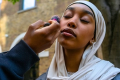 Image Woman wearing a hijab getting her makeup done