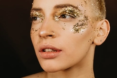 A girl with glitter on her face. 