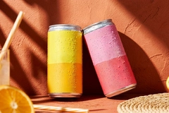 Two cold, unbranded aluminum beverage cans covered in water drops.