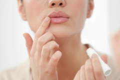 Image Person applying lip care.