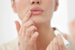 Image Person applying lip care.