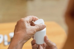 An old person opening a cap