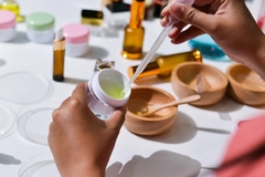 Hands making cosmetics.
