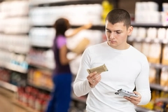 Image Man checking label on nutrition bars