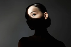 Woman with a shadow over her face