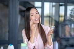 Image Woman applying skin care.