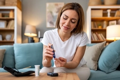 Image woman taking blood glucose levels