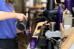 Image Cafe staff fills up reusable cup