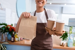 Image Service worker holds paper-based foodservice packaging