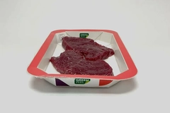 Image red juicy steak in paper packaging tray