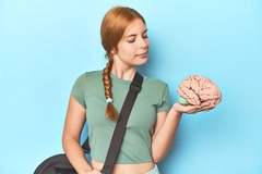 Image girl holds brain model and looks at it