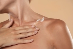 Image body cream on collarbone