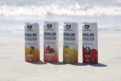 Image 4 cans of a drink on beach