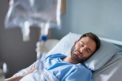 Man resting in hospital bed Man resting in hospital bed