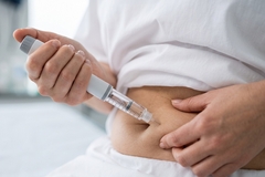 Woman injecting herself with GLP-1 medication