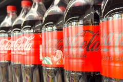 Image Coca-Cola bottles in store.