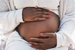 Image pregnant woman holding her hands on belly