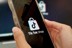 Image Hands holding a phone that has TikTok Shop open.