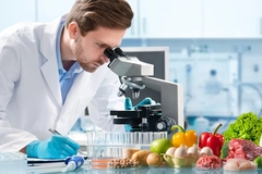 A scientist inspects foods in a lab. A scientist inspects foods in a lab.