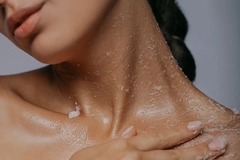Image woman exfoliating with body scrub product