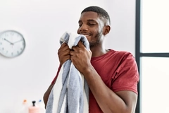Image Man smelling laundry.