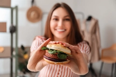 girl holding plant based burger girl holding plant based burger