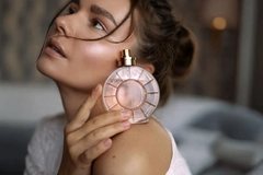 Image woman holding fragrance bottle