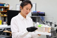 Image Asian female scientist working in lab.