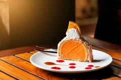 yuzu orange roll cake in white plate on wooden table yuzu orange roll cake in white plate on wooden table