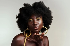 Image Woman with natural hair blowing kiss at the camera