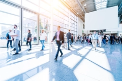 Image People walking in a modern trade show hall.