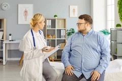 Image Doctor and patient consultation on obesity in clinic
