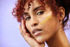 Image A woman's face with dots on it overlayed.