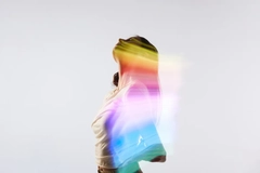 Image A woman with multi-color overlay in front of a white background.