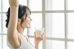 Image Woman drinking milk in the morning at home.