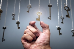 Image Hand choosing a key symbolizing key to success