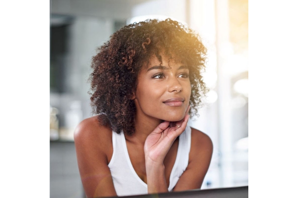 Image natural beauty portrait of young woman with curly hair and glowing skin indoors